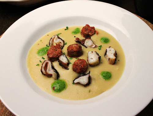 Ham-flavored chickpea puree with grilled octopus, mexican-style chorizo and cilantro salsa verde